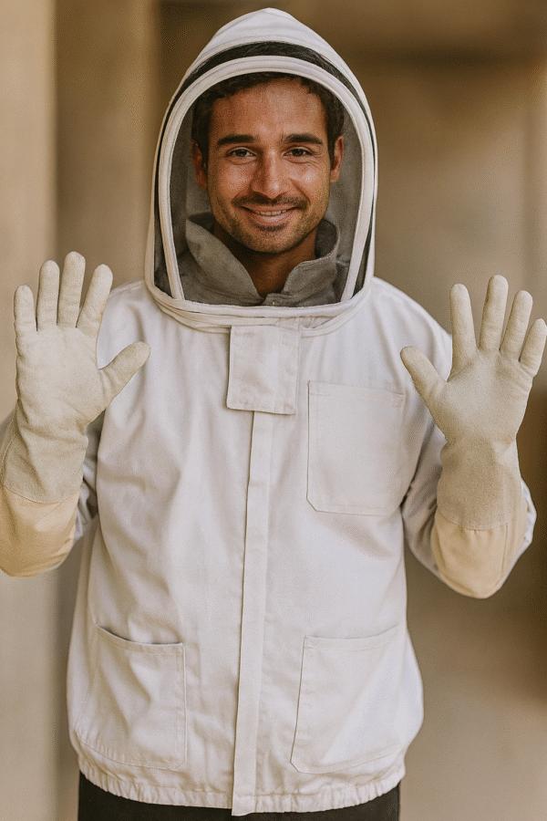 Protective beekeeping suit with zippered hood and elastic cuffs laid flat